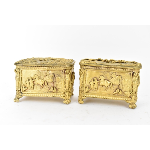 106 - Two 19th century French gilt metal jewellery caskets, each decorated in relief with five panels depi... 