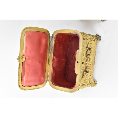 106 - Two 19th century French gilt metal jewellery caskets, each decorated in relief with five panels depi... 