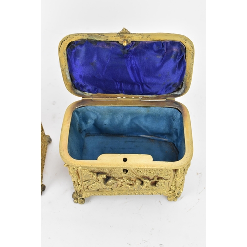 106 - Two 19th century French gilt metal jewellery caskets, each decorated in relief with five panels depi... 