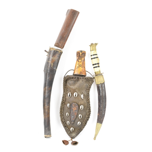 116 - Mixed weapons to include an African dagger having a sheath decorated with cowrie shells, total lengt... 