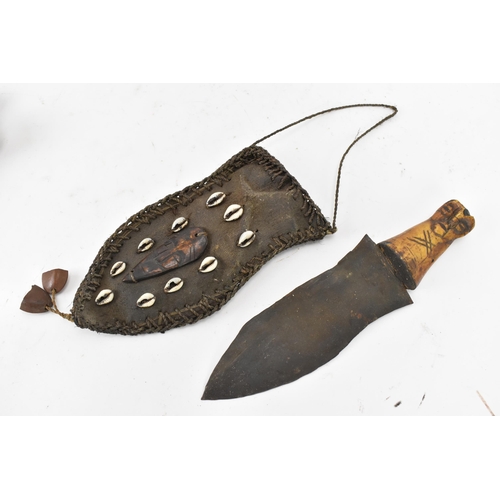 116 - Mixed weapons to include an African dagger having a sheath decorated with cowrie shells, total lengt... 