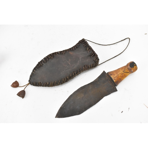 116 - Mixed weapons to include an African dagger having a sheath decorated with cowrie shells, total lengt... 