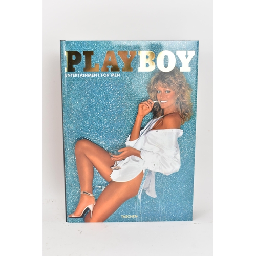 119 - Six volumes of Taschen, Hugh Hefner's Playboy and a reprint of the 1st issue of Playboy, displayed i... 