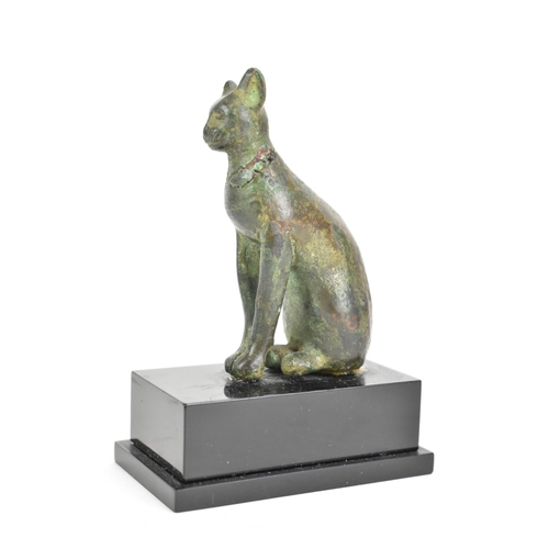 133 - A late Ptolemaic (100-300BC) bronze model of a cat bronze (Bastet), in a seated pose and mounted on ... 