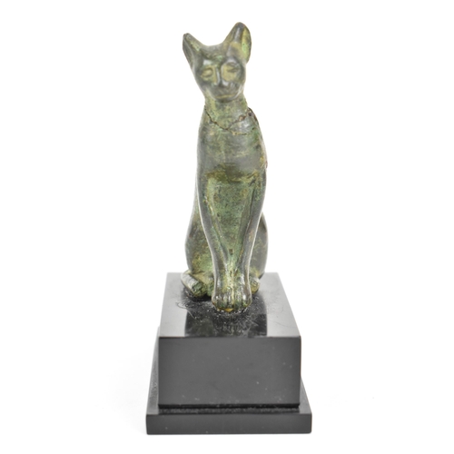 133 - A late Ptolemaic (100-300BC) bronze model of a cat bronze (Bastet), in a seated pose and mounted on ... 