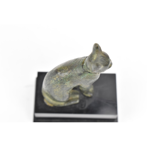 133 - A late Ptolemaic (100-300BC) bronze model of a cat bronze (Bastet), in a seated pose and mounted on ... 