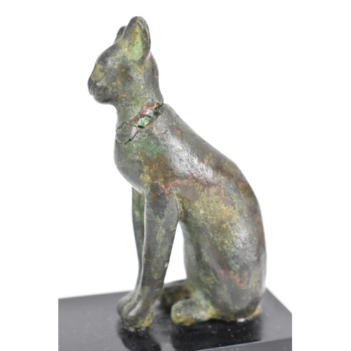 133 - A late Ptolemaic (100-300BC) bronze model of a cat bronze (Bastet), in a seated pose and mounted on ... 