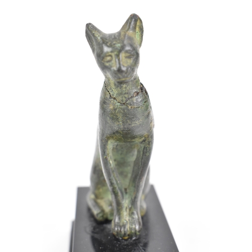 133 - A late Ptolemaic (100-300BC) bronze model of a cat bronze (Bastet), in a seated pose and mounted on ... 