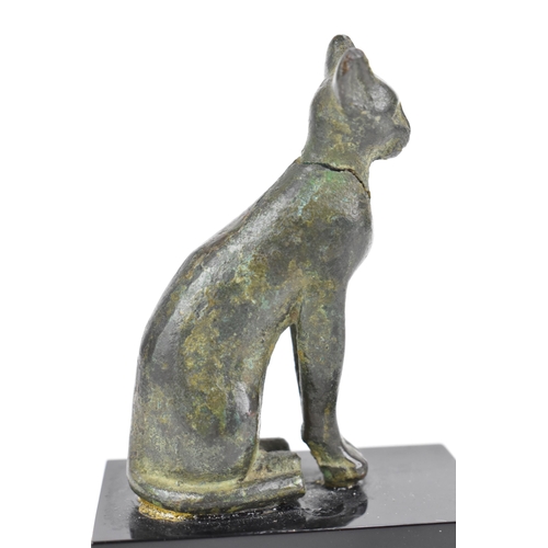 133 - A late Ptolemaic (100-300BC) bronze model of a cat bronze (Bastet), in a seated pose and mounted on ... 