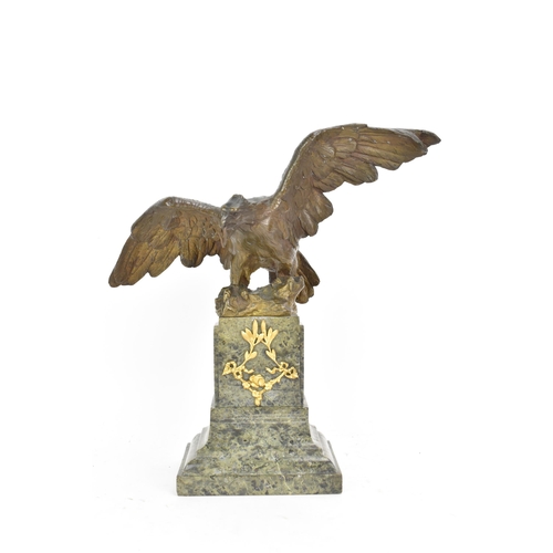 135 - A 19th century French bronze model of an eagle, modelled with outstretched wings with a snake in its... 