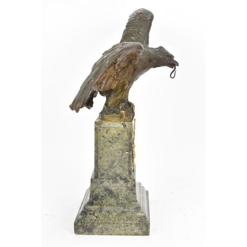 135 - A 19th century French bronze model of an eagle, modelled with outstretched wings with a snake in its... 