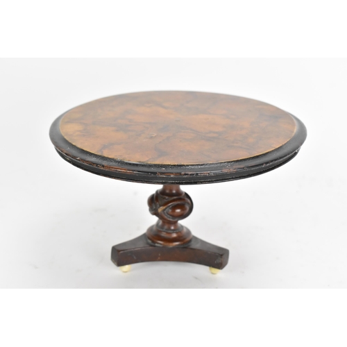 137 - A 19th century walnut table top candle stand, in the form of a breakfast table having a quarter cut ... 