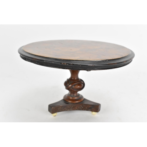 137 - A 19th century walnut table top candle stand, in the form of a breakfast table having a quarter cut ... 