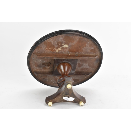 137 - A 19th century walnut table top candle stand, in the form of a breakfast table having a quarter cut ... 