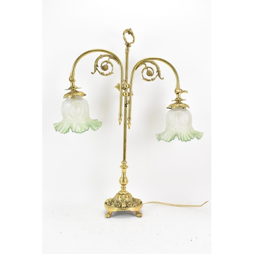 152 - An early 20th century brass adjustable table lamp, having two branches with opalescent green shades,... 