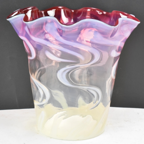 160 - A Victorian glass shade having a wavy formed rim, vaseline glass merging into cranberry surrounded w... 