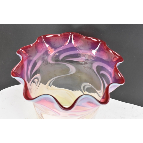 160 - A Victorian glass shade having a wavy formed rim, vaseline glass merging into cranberry surrounded w... 