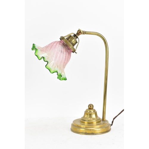 175 - An early 20th century brass table lamp, having a single arm, an adjustable head and an Art Deco gree... 