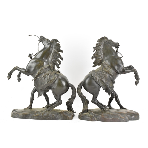 177 - A pair of late 19th/early 20th century French patinated bronze models of the Marly Horses, after Gui... 