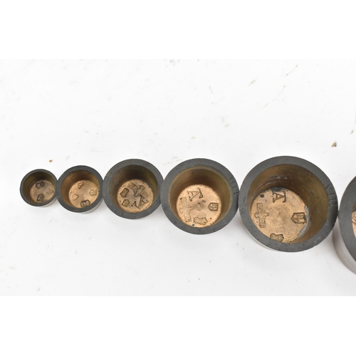 179 - A Georgian bronze set of eight graduated circular cup weights, 7cm high x 10cm wide
If there is no c... 