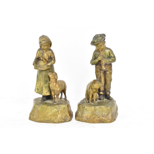 181 - A pair of late 19th/early 20th century Austrian cold cast bronze figures, one of a girl feeding a la... 