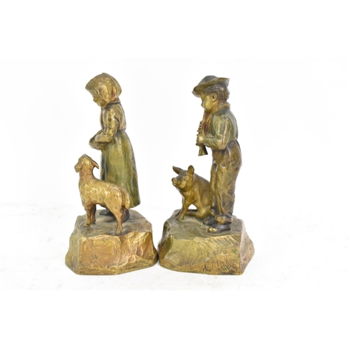 181 - A pair of late 19th/early 20th century Austrian cold cast bronze figures, one of a girl feeding a la... 