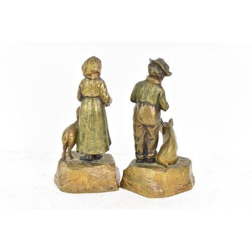 181 - A pair of late 19th/early 20th century Austrian cold cast bronze figures, one of a girl feeding a la... 