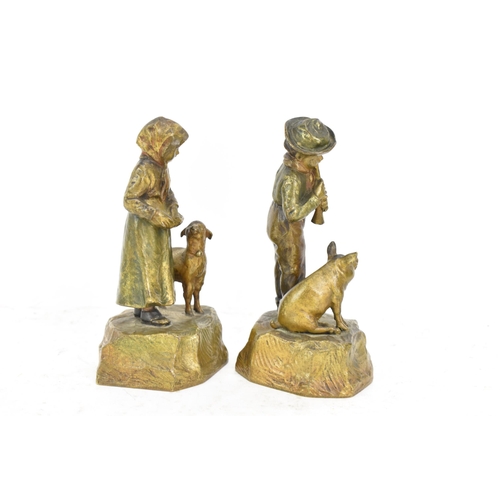 181 - A pair of late 19th/early 20th century Austrian cold cast bronze figures, one of a girl feeding a la... 