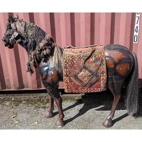 189 - A large Pakistani treen model of a horse with hand woven headstall, browband and seat, 134cm high x ... 