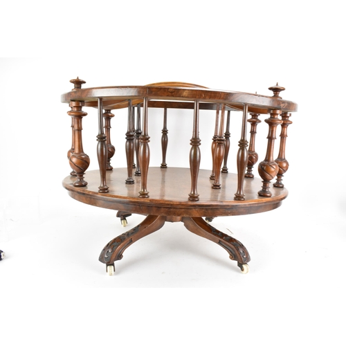 190 - A Victorian walnut Canterbury, of oval form, having turned finials, dividing sections and border sup... 