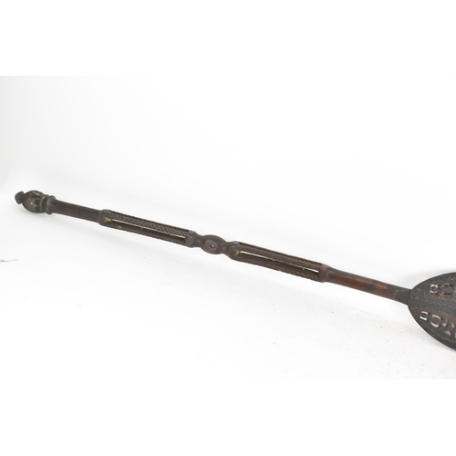 192 - Two tribal carved ceremonial paddles, each with an elongated leaf shape paddle, 161cm high and 158cm... 