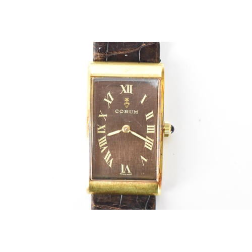 23 - A Corum, manual wind, gents, 18ct gold wristwatch, the rectangular brown dial having Roman numerals,... 