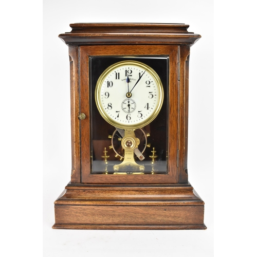 33 - An early 20th century Eureka electric mahogany cased mantle clock, the enamel dial having Arabic num... 