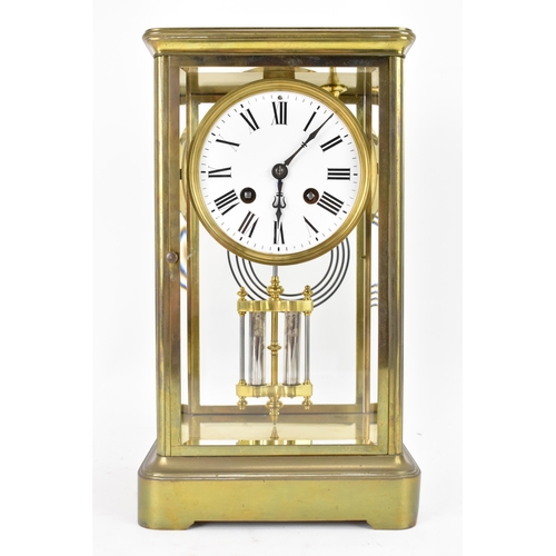 36 - A late 19th century French gilt metal and bevelled glass mantle clock, the white enamel dial having ... 