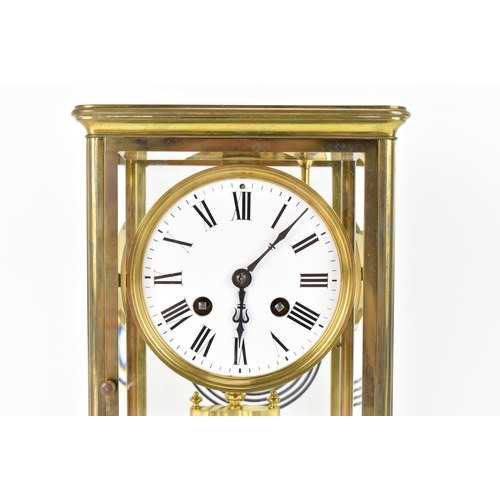 36 - A late 19th century French gilt metal and bevelled glass mantle clock, the white enamel dial having ... 