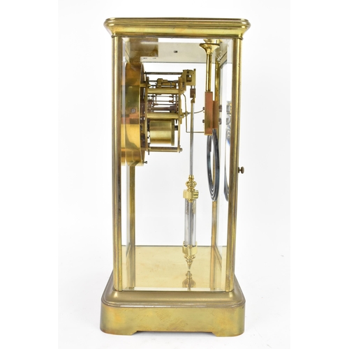 36 - A late 19th century French gilt metal and bevelled glass mantle clock, the white enamel dial having ... 