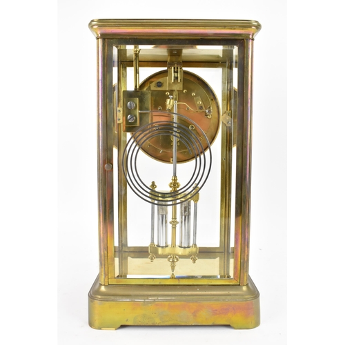 36 - A late 19th century French gilt metal and bevelled glass mantle clock, the white enamel dial having ... 