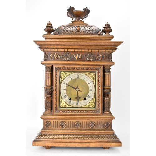 45 - A late 19th century German walnut cased 8 day mantle clock, the case of architectural form having a ... 