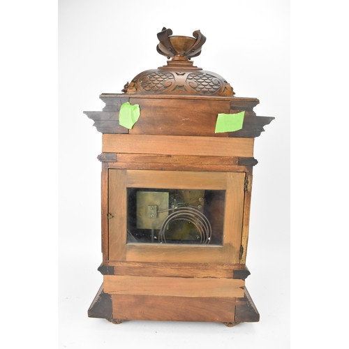 45 - A late 19th century German walnut cased 8 day mantle clock, the case of architectural form having a ... 