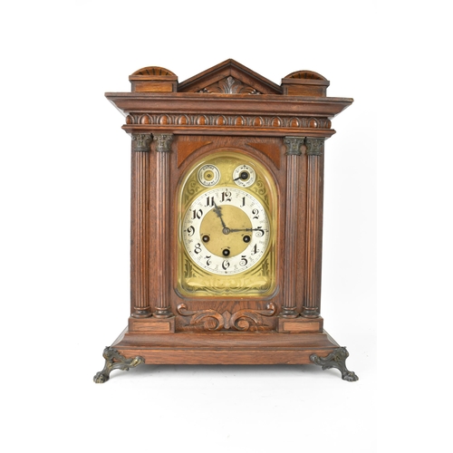 46 - A circa 1900 Junghans oak cased mantle clock, the case of architectural form with egg and dart mould... 