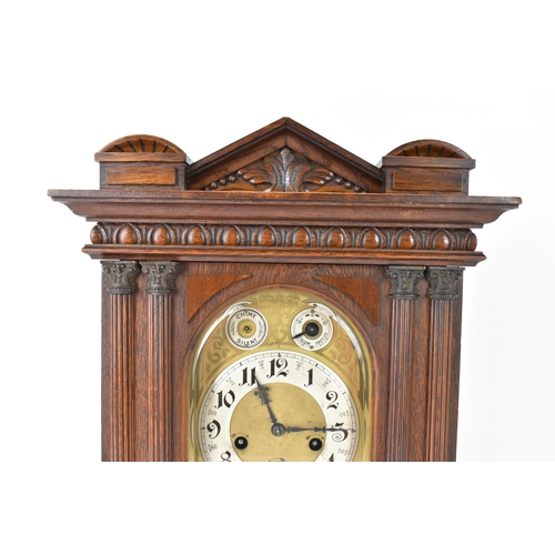 46 - A circa 1900 Junghans oak cased mantle clock, the case of architectural form with egg and dart mould... 