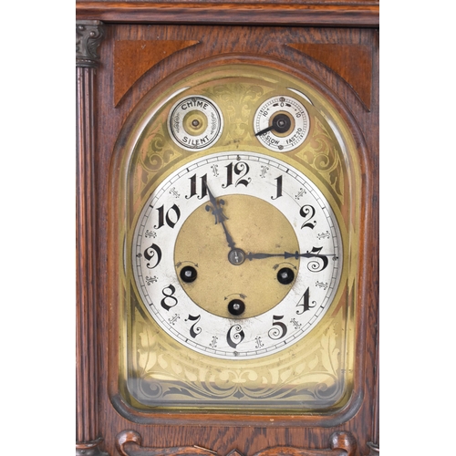 46 - A circa 1900 Junghans oak cased mantle clock, the case of architectural form with egg and dart mould... 