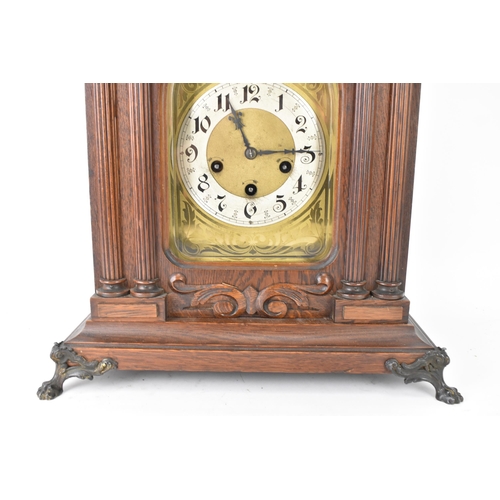 46 - A circa 1900 Junghans oak cased mantle clock, the case of architectural form with egg and dart mould... 