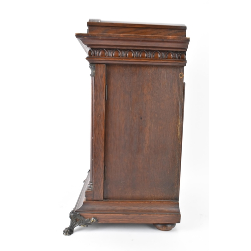 46 - A circa 1900 Junghans oak cased mantle clock, the case of architectural form with egg and dart mould... 