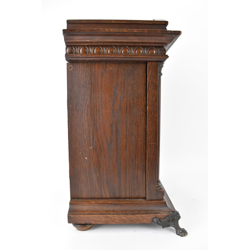 46 - A circa 1900 Junghans oak cased mantle clock, the case of architectural form with egg and dart mould... 