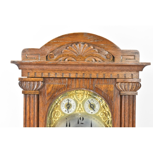 47 - A circa 1900 oak cased mantle clock, the case of architectural form with an arched top, dental mould... 