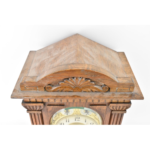 47 - A circa 1900 oak cased mantle clock, the case of architectural form with an arched top, dental mould... 