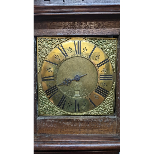 49 - An early 18th century oak cased 30 hour longcase clock, the case having a moulded cornice with a lat... 