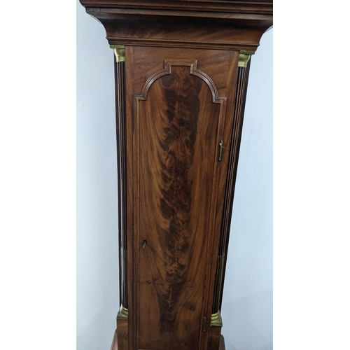 50 - An early 19th century mahogany 8 day longcase clock, having an arched top with pierced grille above ... 