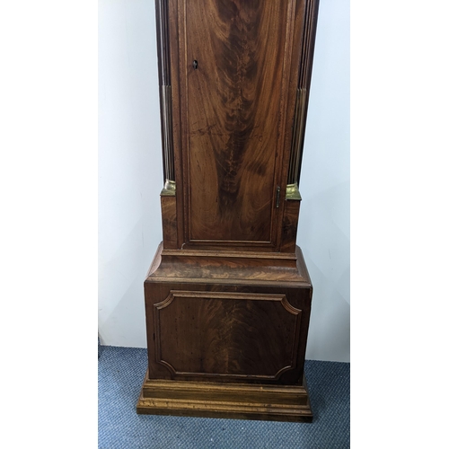 50 - An early 19th century mahogany 8 day longcase clock, having an arched top with pierced grille above ... 